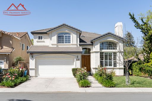 Front exterior of the two-story single-family home at 10415 Stern Avenue, Cupertino, with attached garage