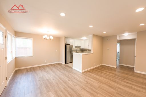 Open-concept living and dining area with recessed lighting and wood-style flooring