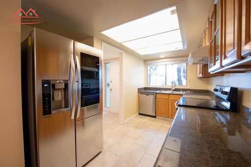 Remodeled kitchen with granite counters and stainless steel appliances
