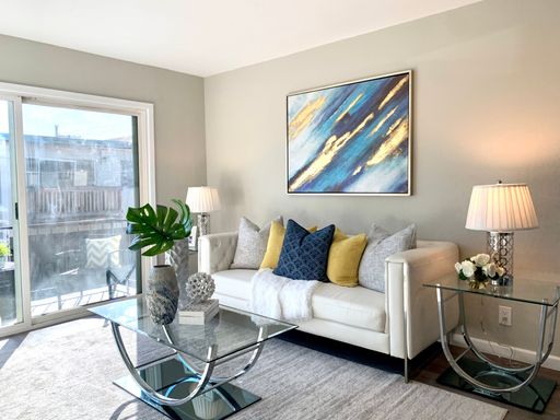Bright living room with sliding door to the balcony at 3873 Starview Drive #3, San Jose (shown staged; rents unfurnished)