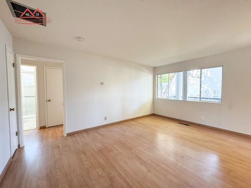 Bright living room with wood flooring and large windows