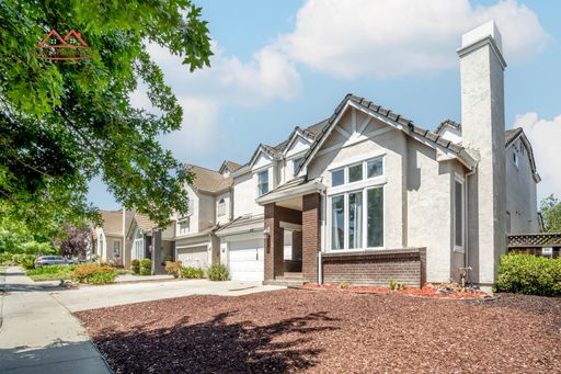 Front exterior of the two-story family home at 6497 Hirabayashi Drive, San Jose
